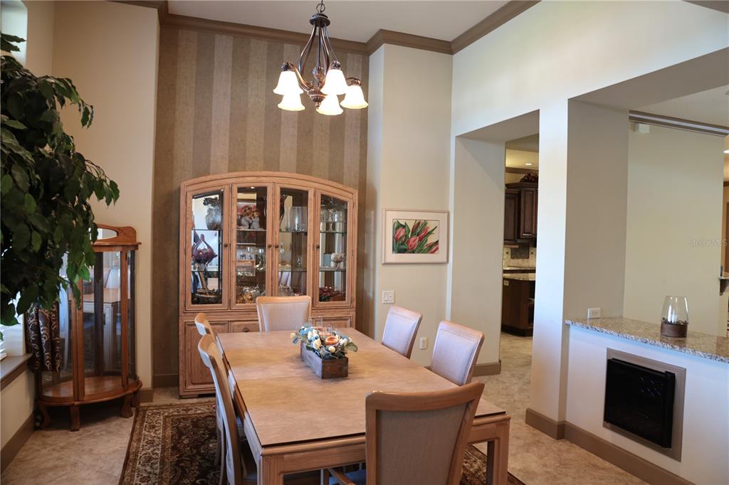 6656 Southwest 179th Ave Road Dunnellon, FL 34432 - Photo 14 of 43 a view of a dining room with furniture and chandelier