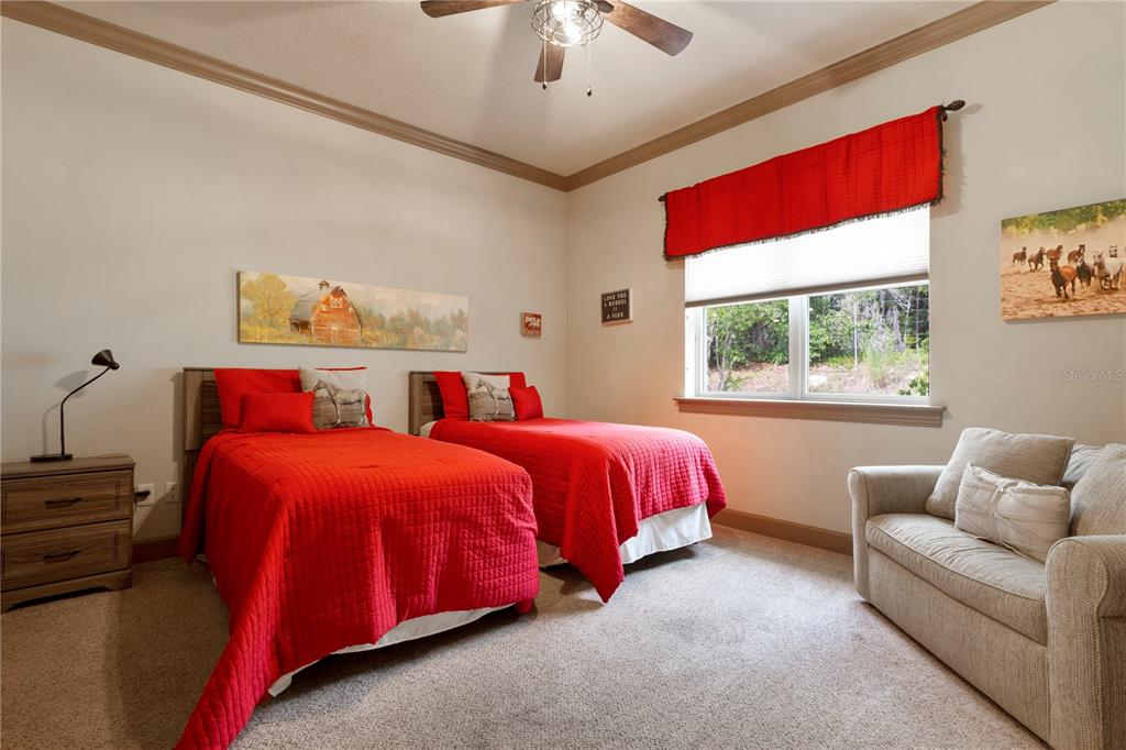 6656 Southwest 179th Ave Road Dunnellon, FL 34432 - Photo 26 of 43 a bedroom with two beds and a chandelier