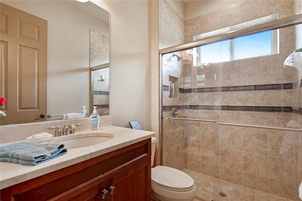 6656 Southwest 179th Ave Road Dunnellon, FL 34432 - Photo 27 of 43 a bathroom with a granite countertop sink toilet a mirror and shower