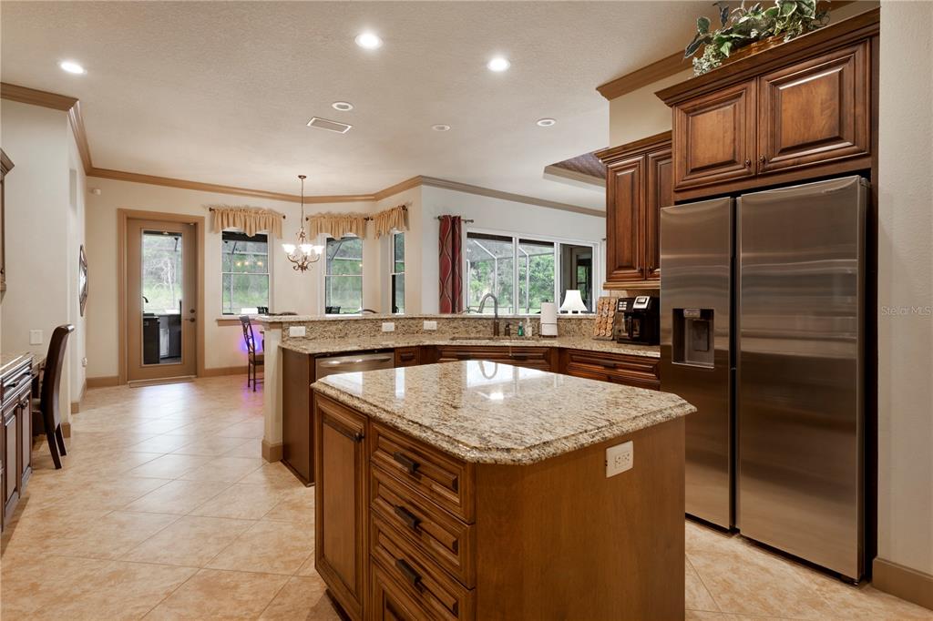 6656 Southwest 179th Ave Road Dunnellon, FL 34432 - Photo 6 of 43 a kitchen with stainless steel appliances granite countertop a sink and a refrigerator
