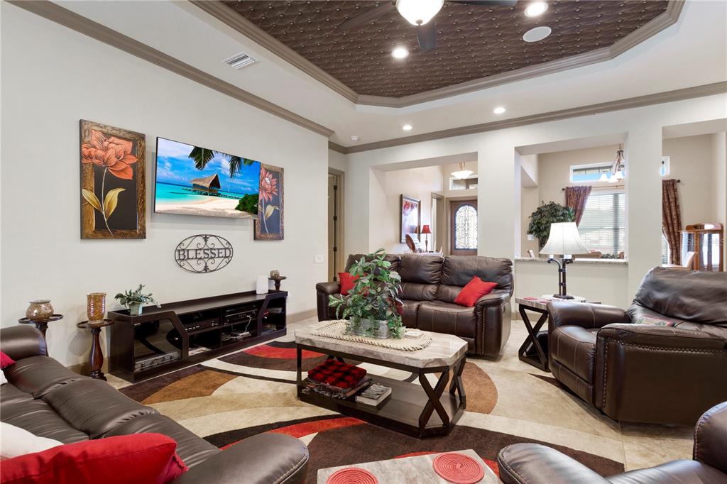 6656 Southwest 179th Ave Road Dunnellon, FL 34432 - Photo 9 of 43 a living room with furniture a flat screen tv and a chandelier