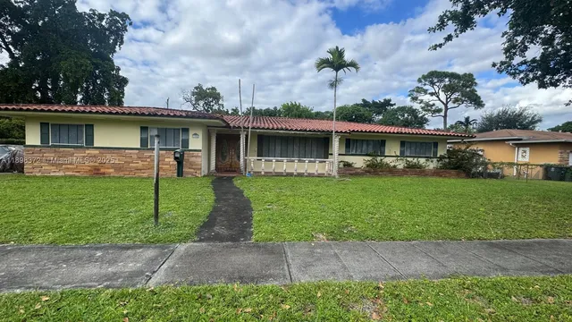 a front view of house with a garden and patio