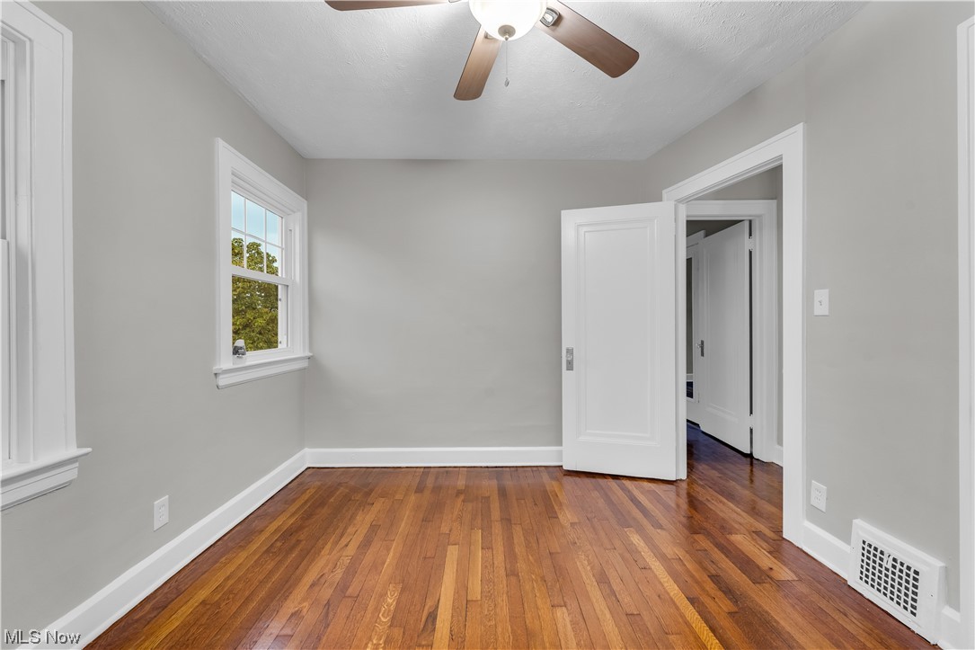 3445 Menlo Road Cleveland, OH 44120 - Photo 17 of 35 Empty room featuring hardwood flooring and ceiling fan