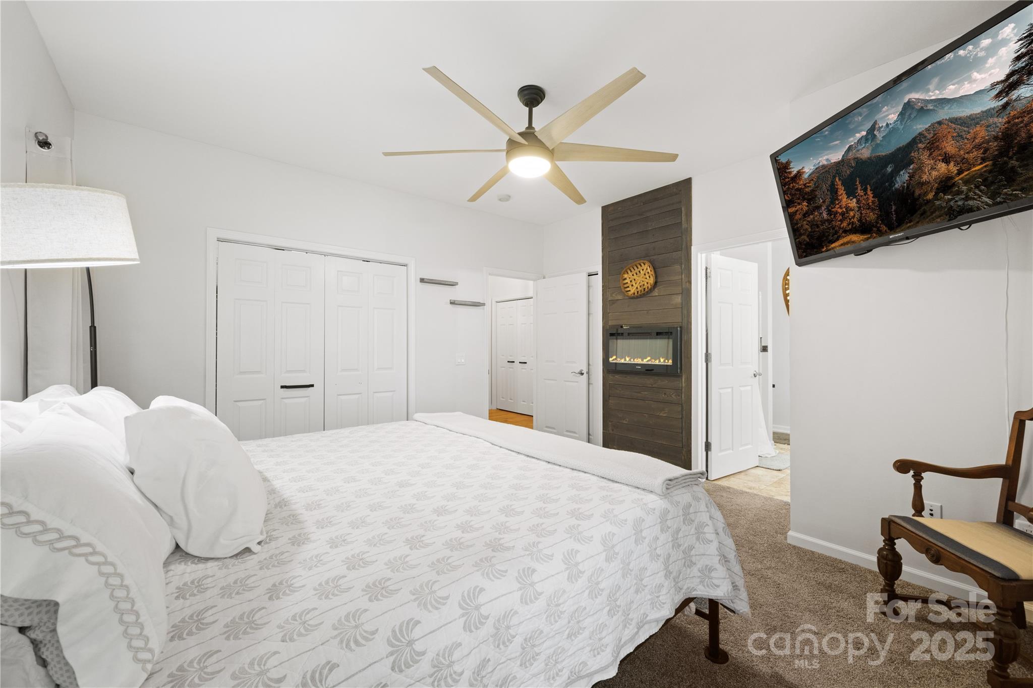 1308 Bell Mountain Road Zirconia, NC 28790 - Photo 20 of 42 a bedroom with a bed and a flat tv screen on dresser