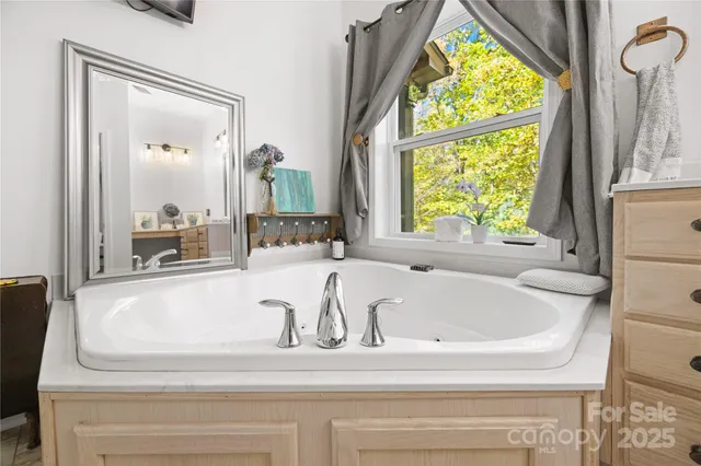 a white bath tub sitting next to a window