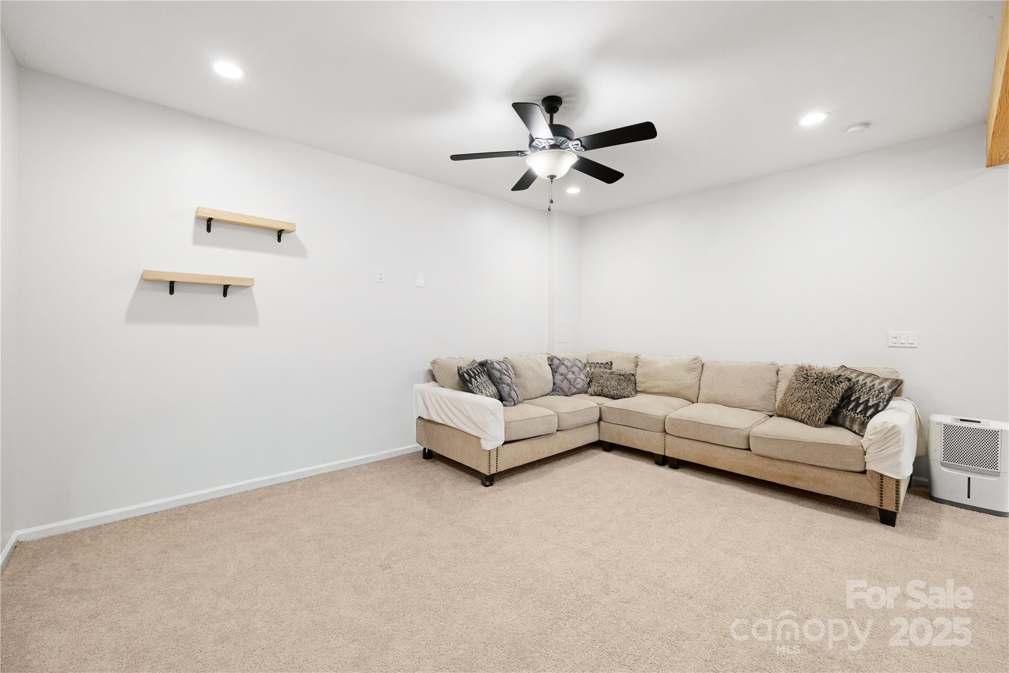 1308 Bell Mountain Road Zirconia, NC 28790 - Photo 26 of 42 a living room with furniture and a ceiling fan
