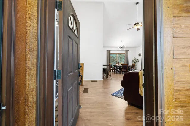 a walk in closet with view of bathroom