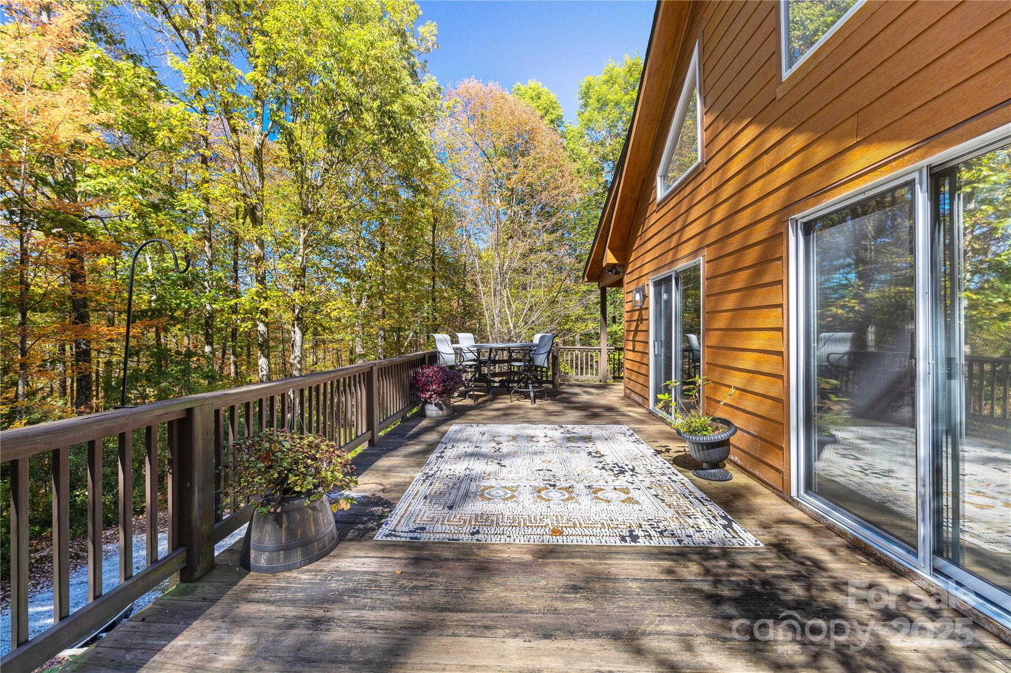 1308 Bell Mountain Road Zirconia, NC 28790 - Photo 32 of 42 a view of a patio with table and chairs and wooden fence