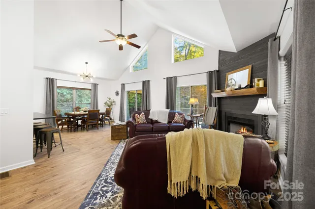 a living room with furniture a fireplace and a ceiling fan