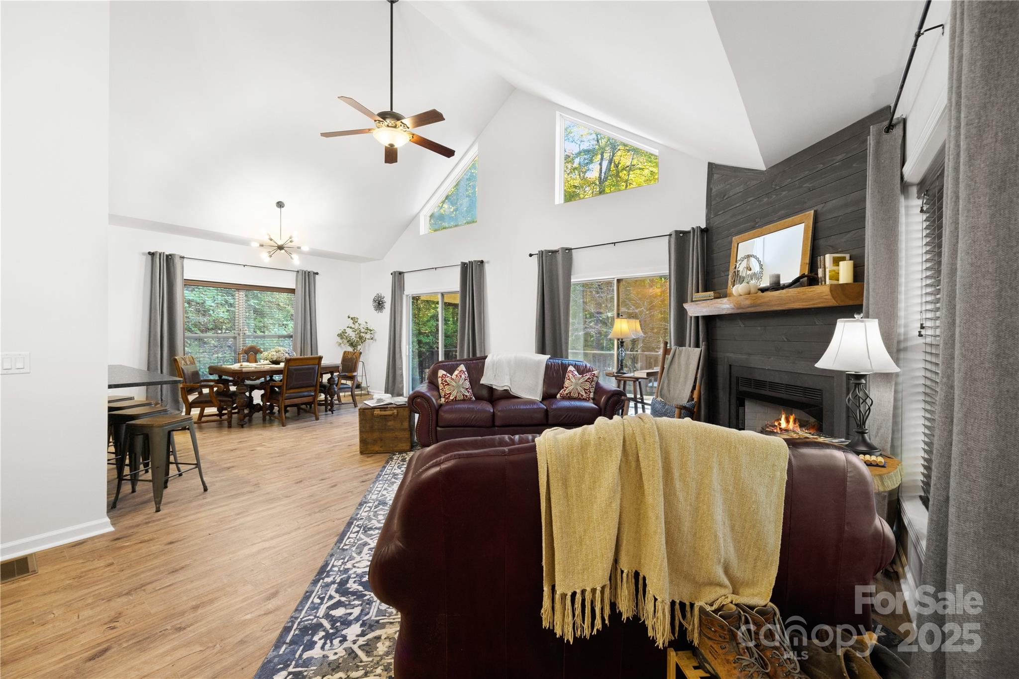 1308 Bell Mountain Road Zirconia, NC 28790 - Photo 4 of 42 a living room with furniture a fireplace and a ceiling fan