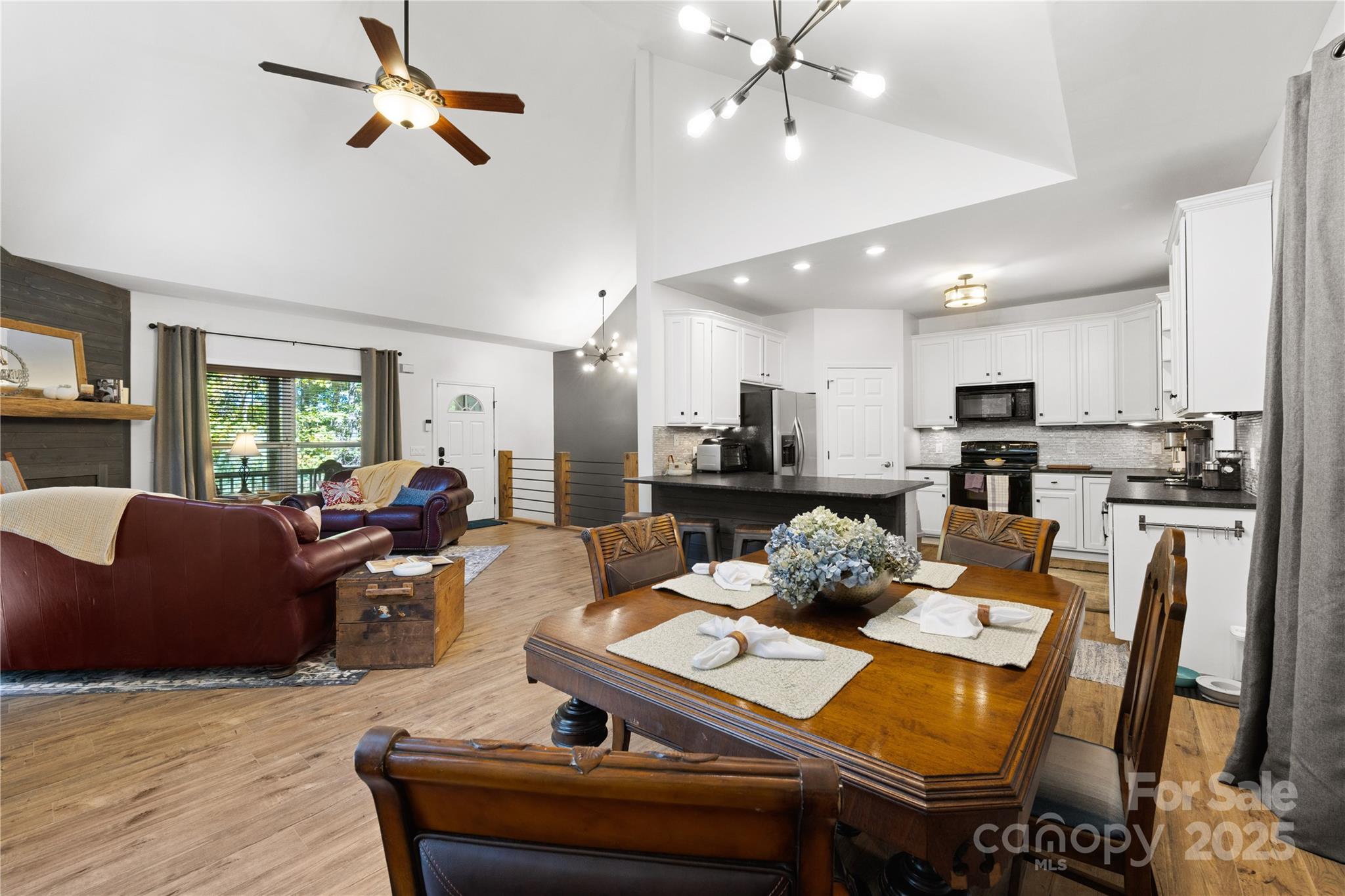 1308 Bell Mountain Road Zirconia, NC 28790 - Photo 8 of 42 a living room with furniture kitchen view and a chandelier