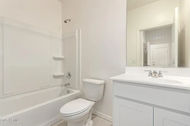 a bathroom with a granite countertop toilet a sink and a bathtub