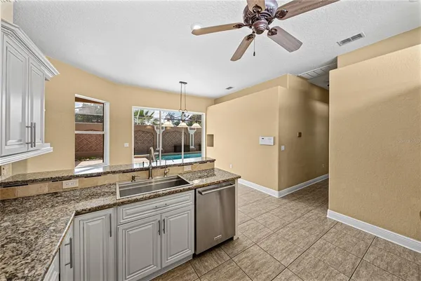 a spacious bathroom with a granite countertop sink a mirror and a shower