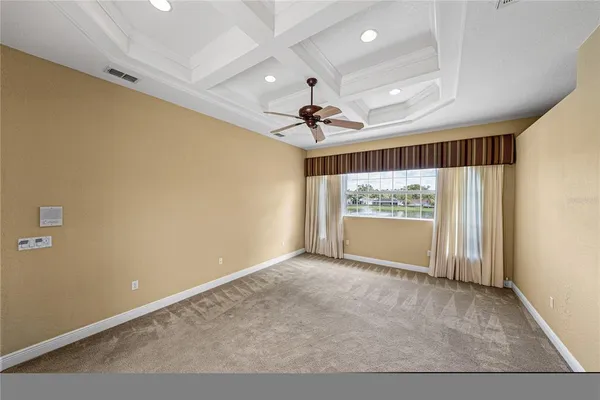 a view of room with hardwood floor and ceiling fan