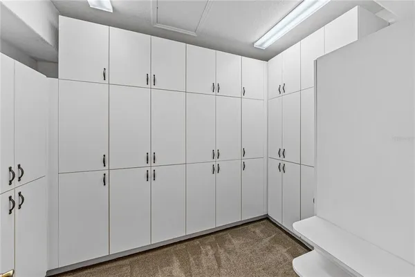 a outdoor space with lots of chairs and chandelier