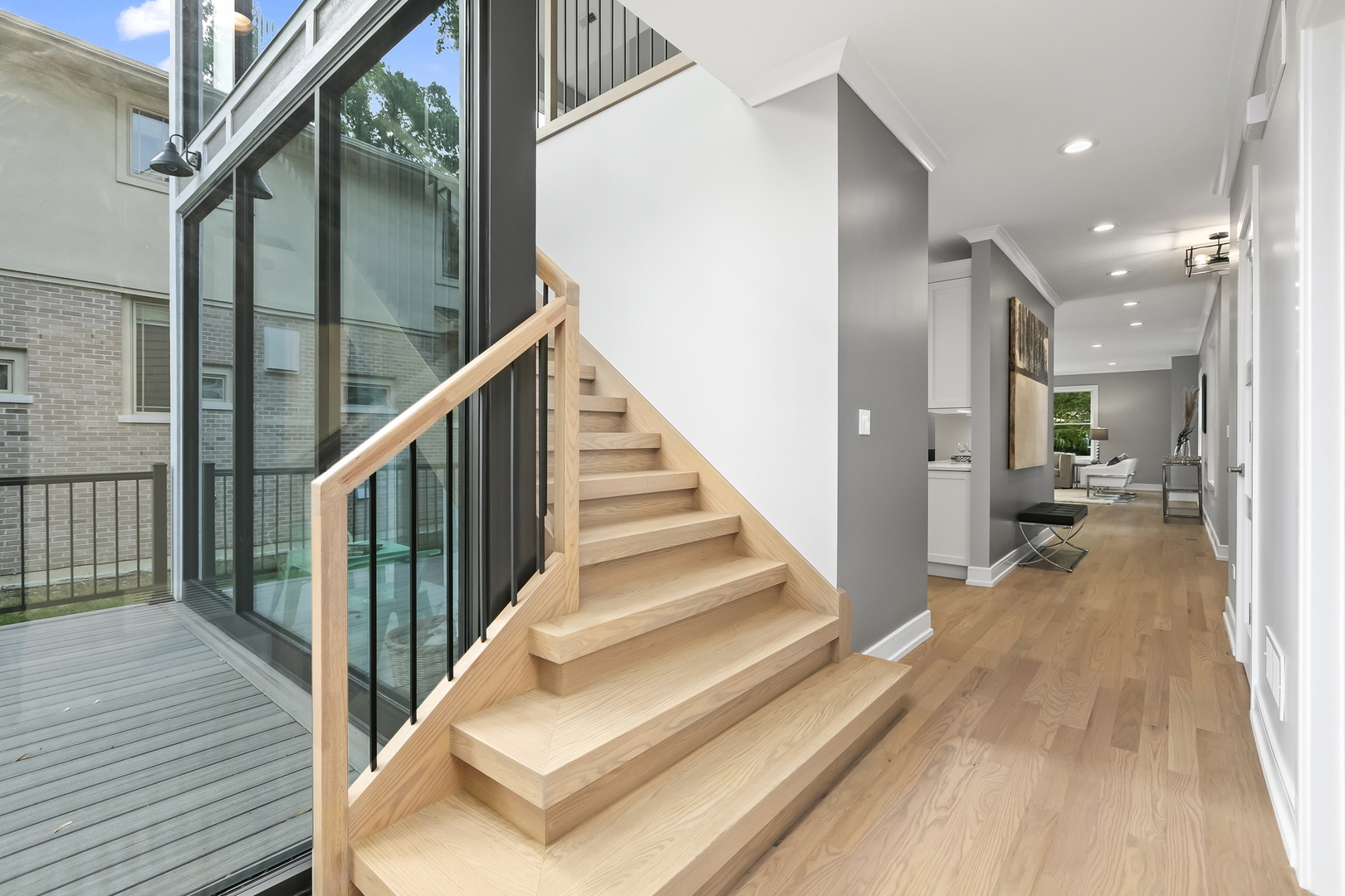 220 Spring Avenue Naperville, IL 60540 - Photo 19 of 52 a view of a hallway with wooden floor and staircase