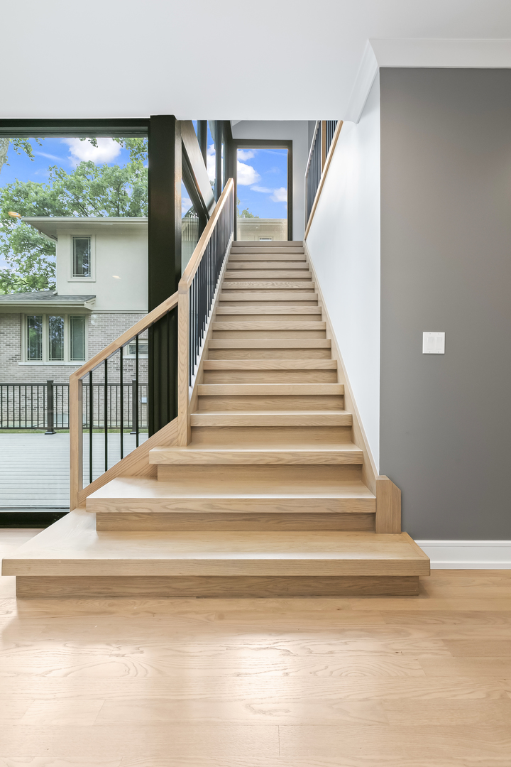 220 Spring Avenue Naperville, IL 60540 - Photo 24 of 52 a view of staircase with white walls and windows