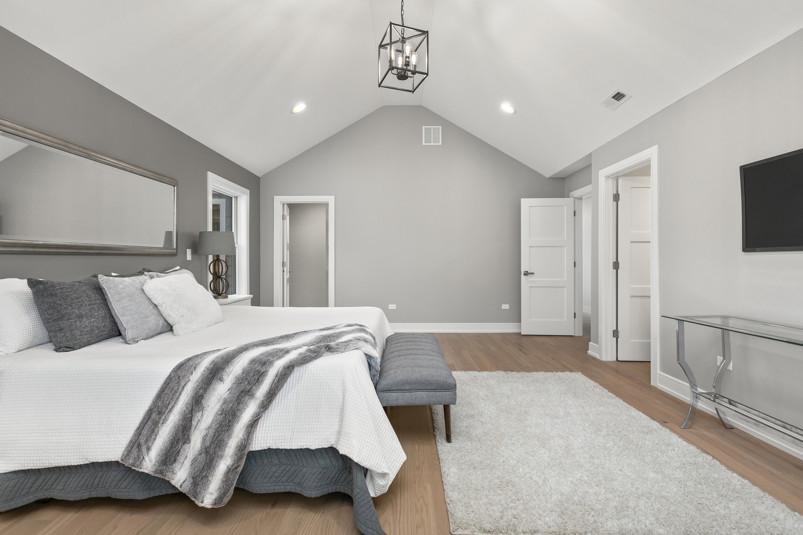 220 Spring Avenue Naperville, IL 60540 - Photo 30 of 52 a spacious bedroom with a bed and a flat screen tv
