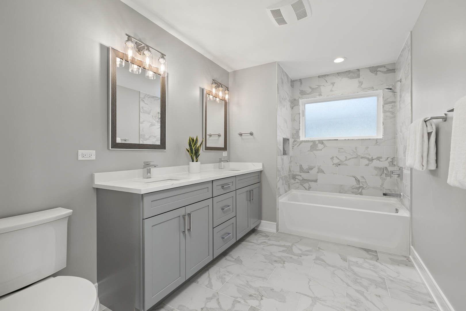 220 Spring Avenue Naperville, IL 60540 - Photo 36 of 52 a bathroom with a tub sink toilet and a mirror