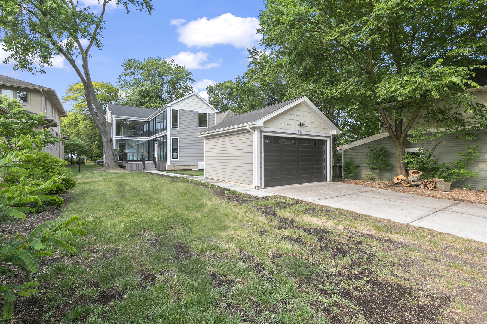 220 Spring Avenue Naperville, IL 60540 - Photo 52 of 52 a front view of a house with a garden and trees