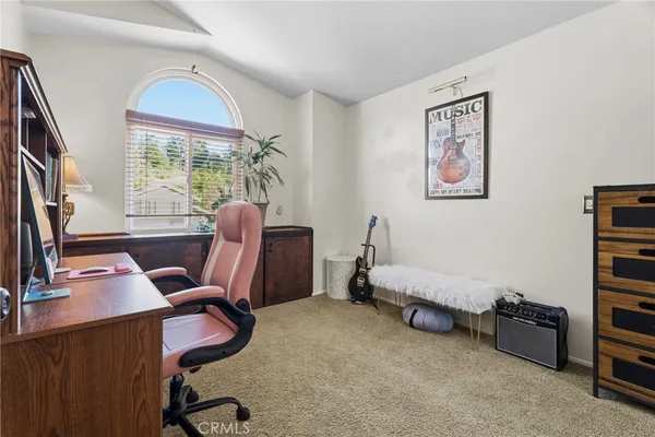 a view of a workspace with furniture and a window