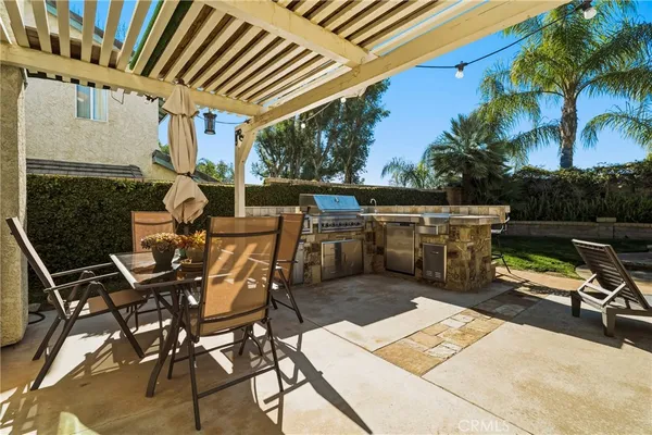 a view of a patio with table and chairs and potted plants
