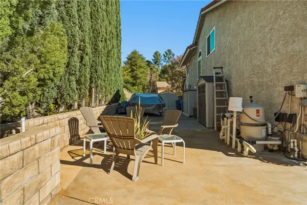 a view of a chairs and table in patio