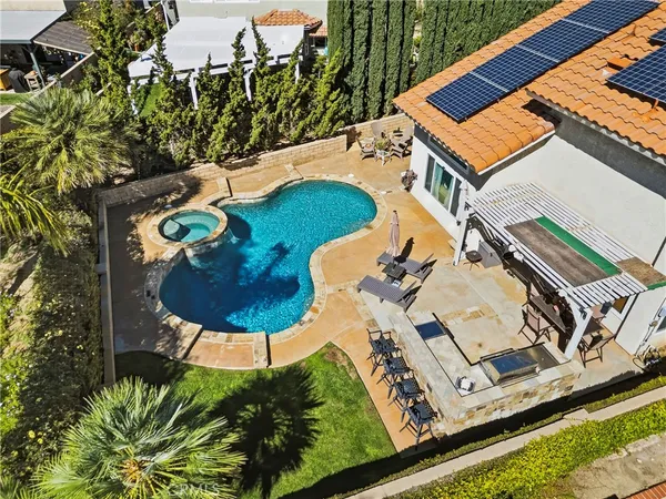an aerial view of a backyard with table and chairs