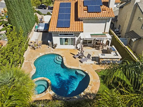 an aerial view of a house with swimming pool and outdoor space