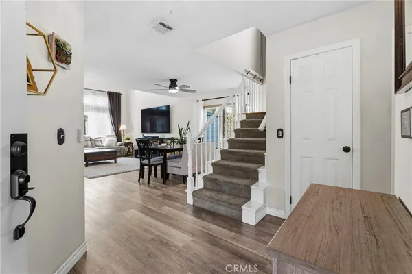 a view of entryway and hall with wooden floor