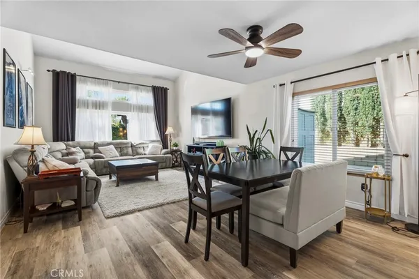 a living room with furniture and wooden floor