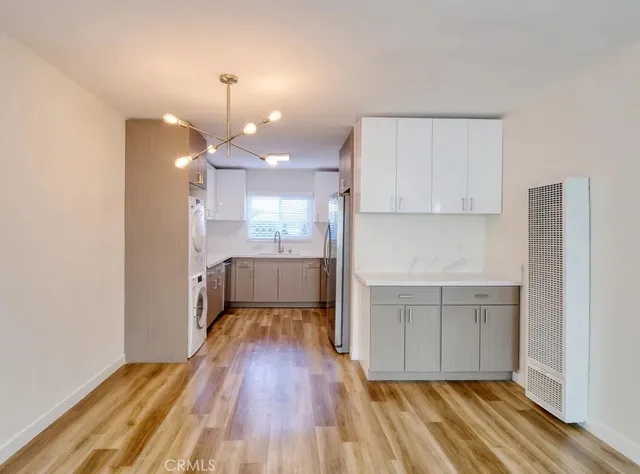 a view of a kitchen with wooden floor and a sink