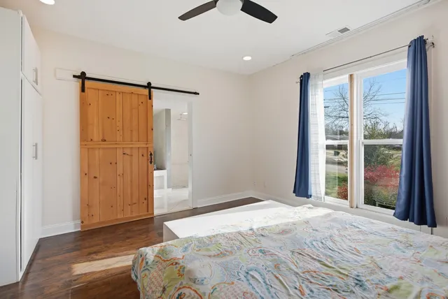 a bedroom with a large bed and a large window