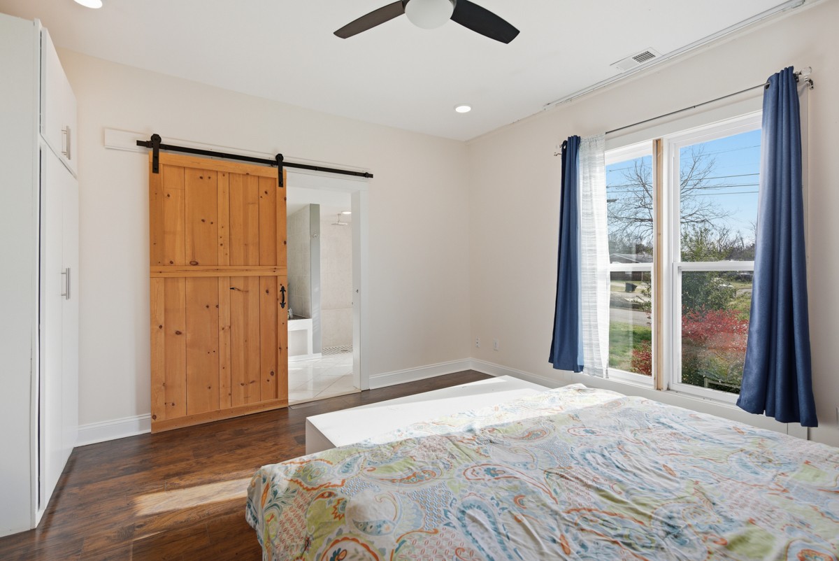 107 East Ward Street Centerville, TN 37033 - Photo 15 of 34 a bedroom with a large bed and a large window