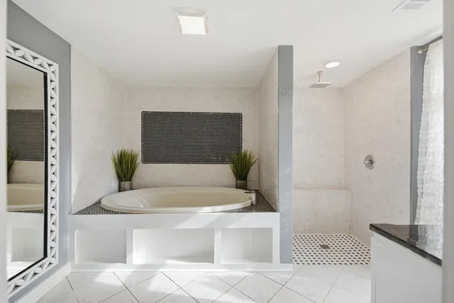 a bathroom with a bathtub and shower