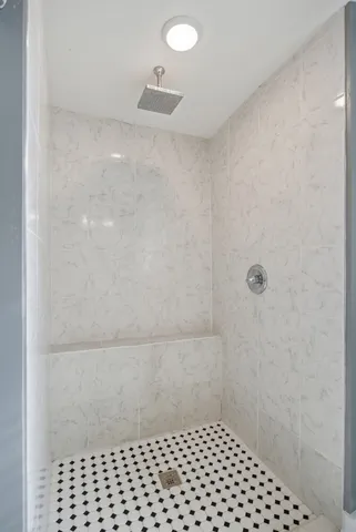 a bathroom with a bathtub and mirror