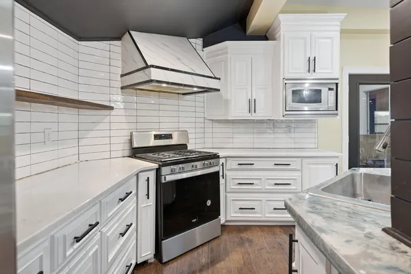 a kitchen with cabinets appliances and a sink