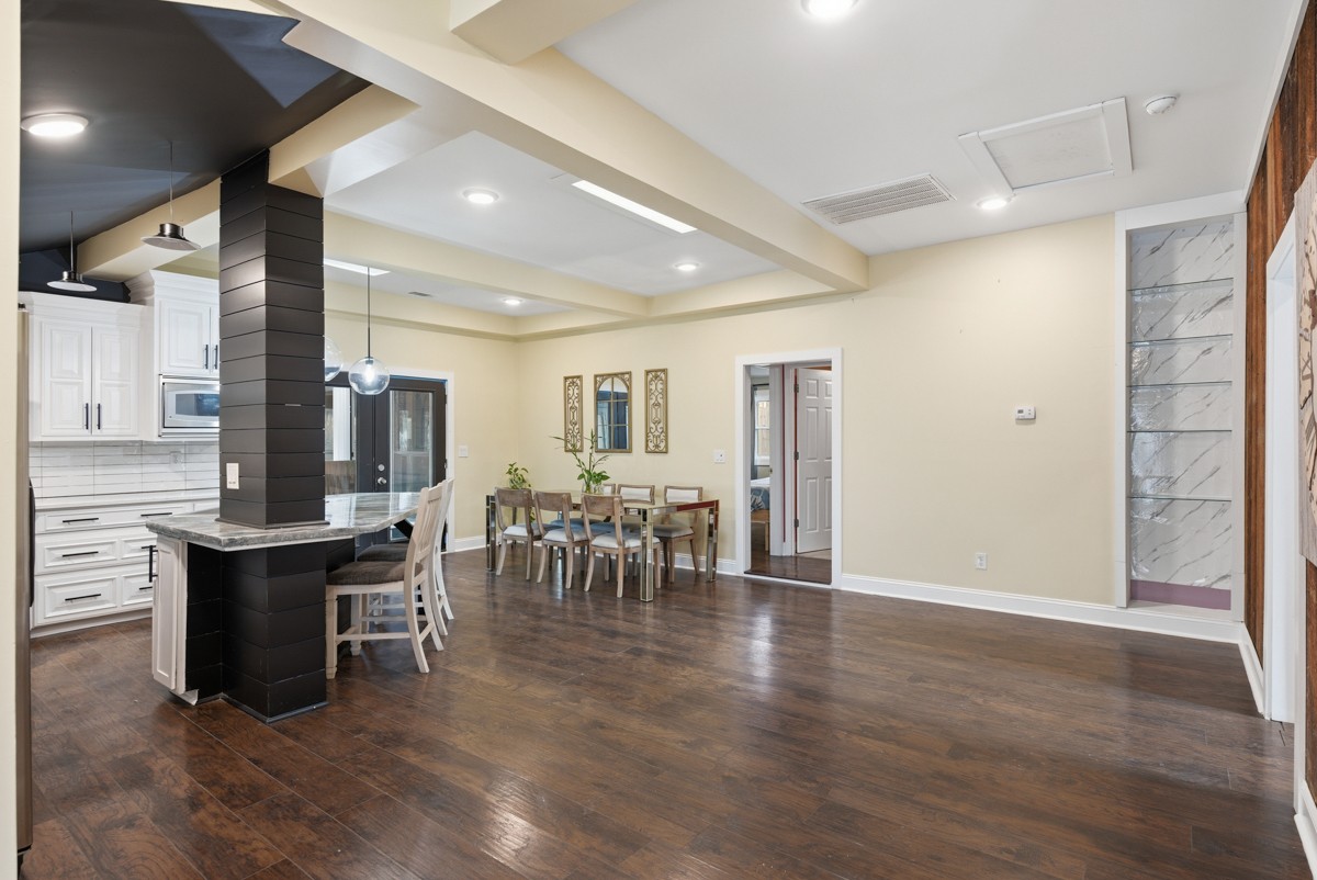 107 East Ward Street Centerville, TN 37033 - Photo 9 of 34 a dining hall with stainless steel appliances granite countertop a table chairs and a sink