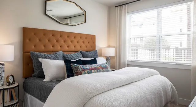 a bedroom with a large bed and a large window