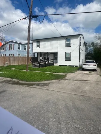 a view of a house with a yard and garage