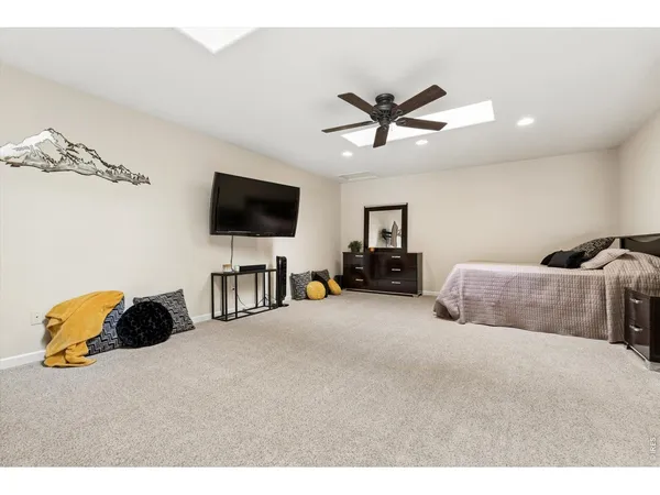 a bedroom with a bed and a ceiling fan