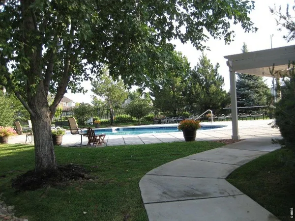 a view of a lake with a bench and trees around