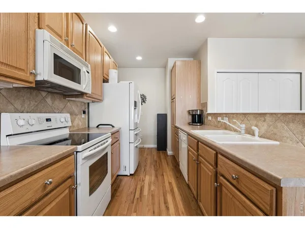 a bathroom with a granite countertop sink mirror vanity and toilet