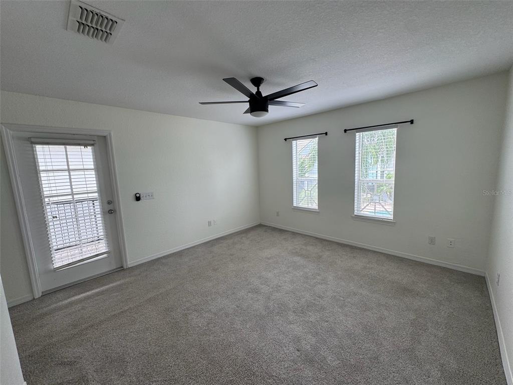 4004 Foxtail Palm Court, Unit 4004 Tampa, FL 33624 - Photo 21 of 49 an empty room with windows and ceiling fan