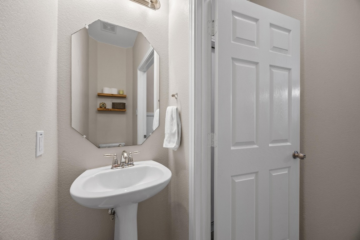 1310 West Parmer Lane, Unit 9B Austin, TX 78727 - Photo 15 of 38 a bathroom with a sink a mirror and shower