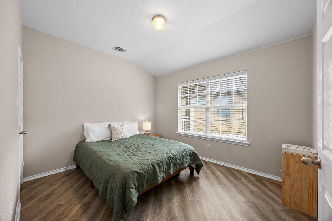 1310 West Parmer Lane, Unit 9B Austin, TX 78727 - Photo 24 of 38 a bedroom with a bed and a window