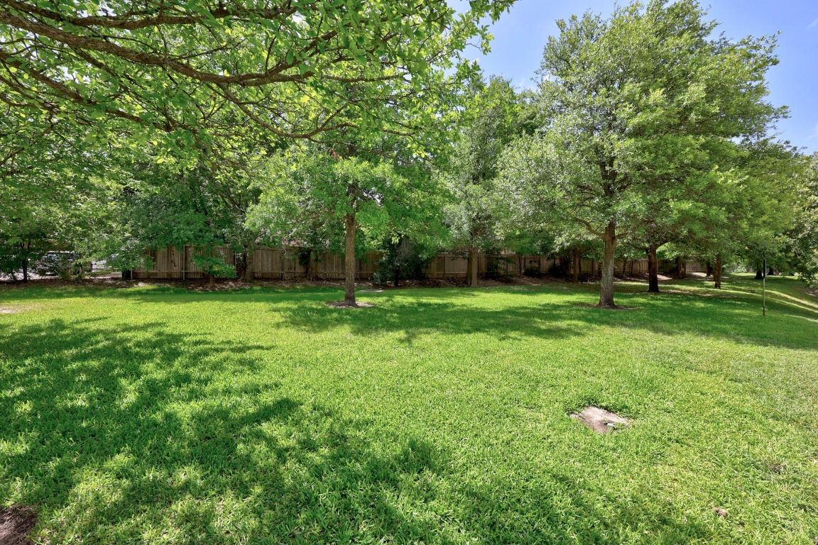 1310 West Parmer Lane, Unit 9B Austin, TX 78727 - Photo 34 of 38 a view of a grassy field with trees