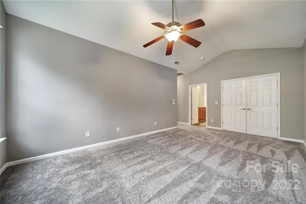 1704 Quartz Lane Fort Mill, SC 29708 - Photo 13 of 39 an empty room with chandelier fan and windows
