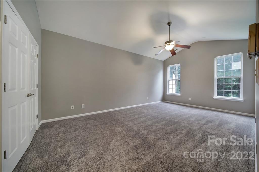 1704 Quartz Lane Fort Mill, SC 29708 - Photo 15 of 39 an empty room with windows and chandelier