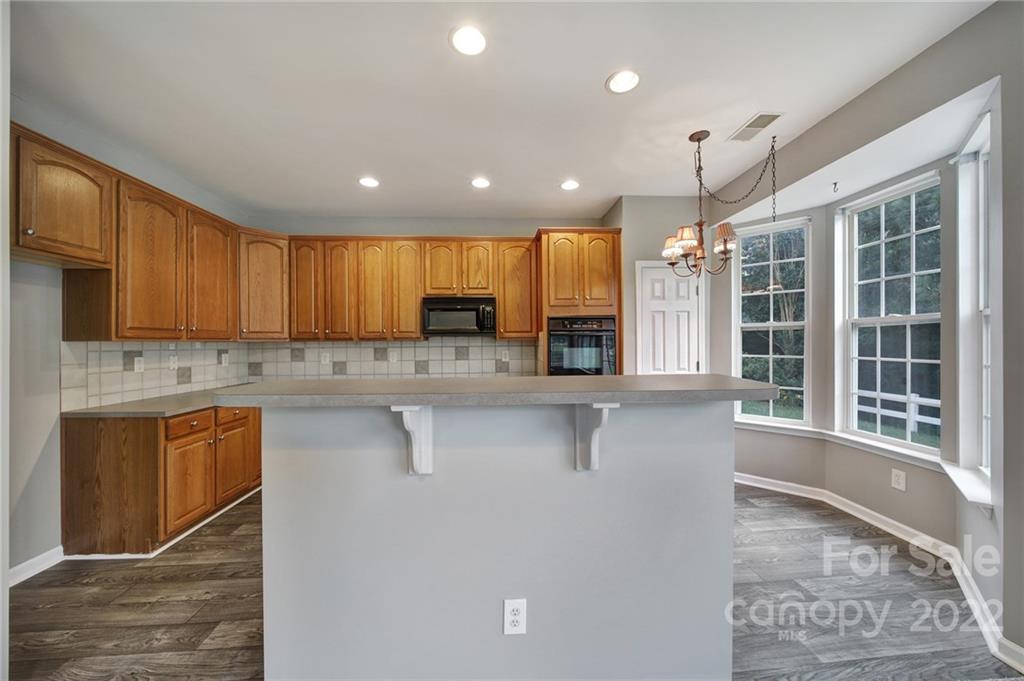 1704 Quartz Lane Fort Mill, SC 29708 - Photo 5 of 39 a kitchen with stainless steel appliances granite countertop a sink a stove a refrigerator cabinets and living room view